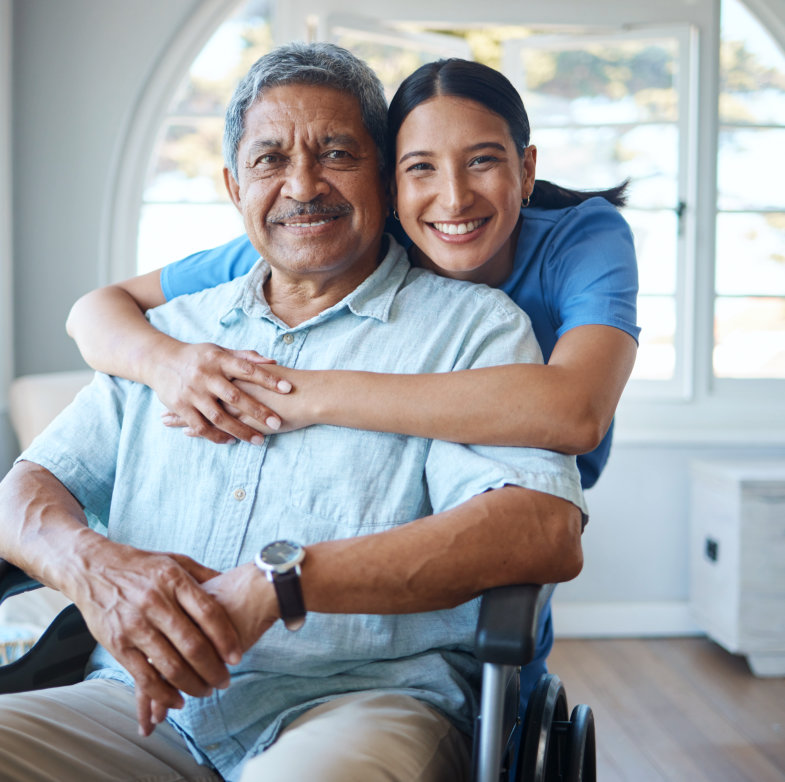 a female caregiver hugging an elderly man