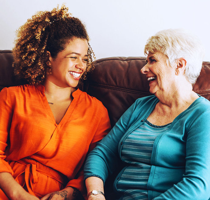 A female and an elderly woman looking at each other