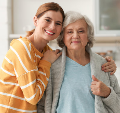 A female hugging an elderly woman