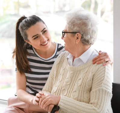 a female and an elderly woman looking at each other