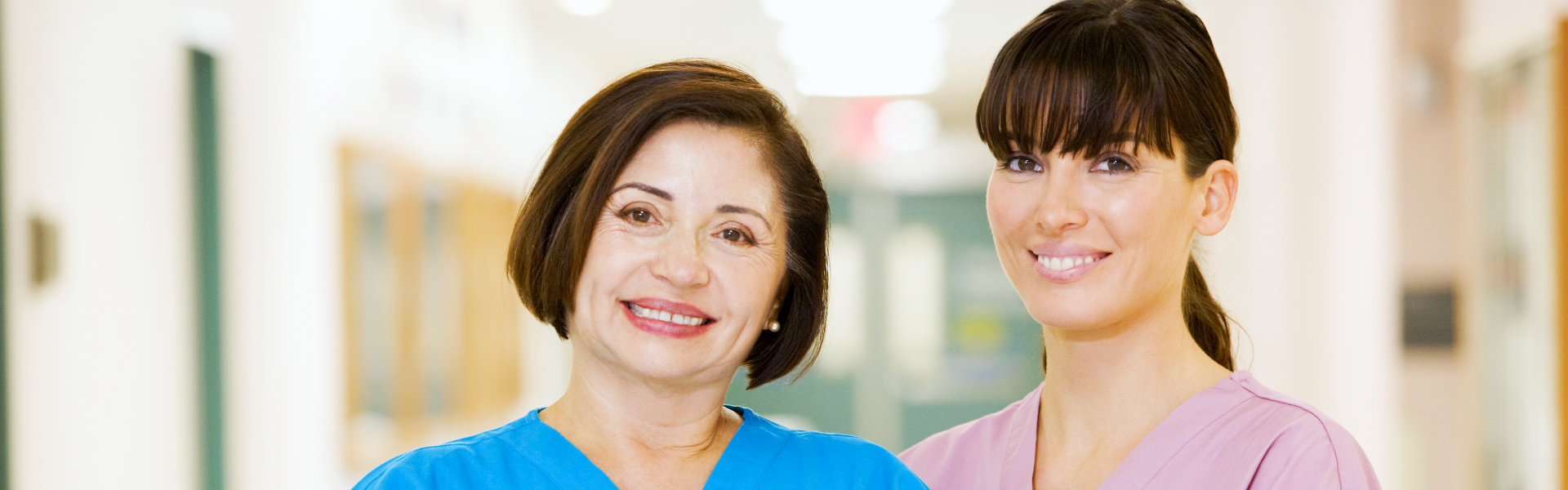 Two female caregiver smiling